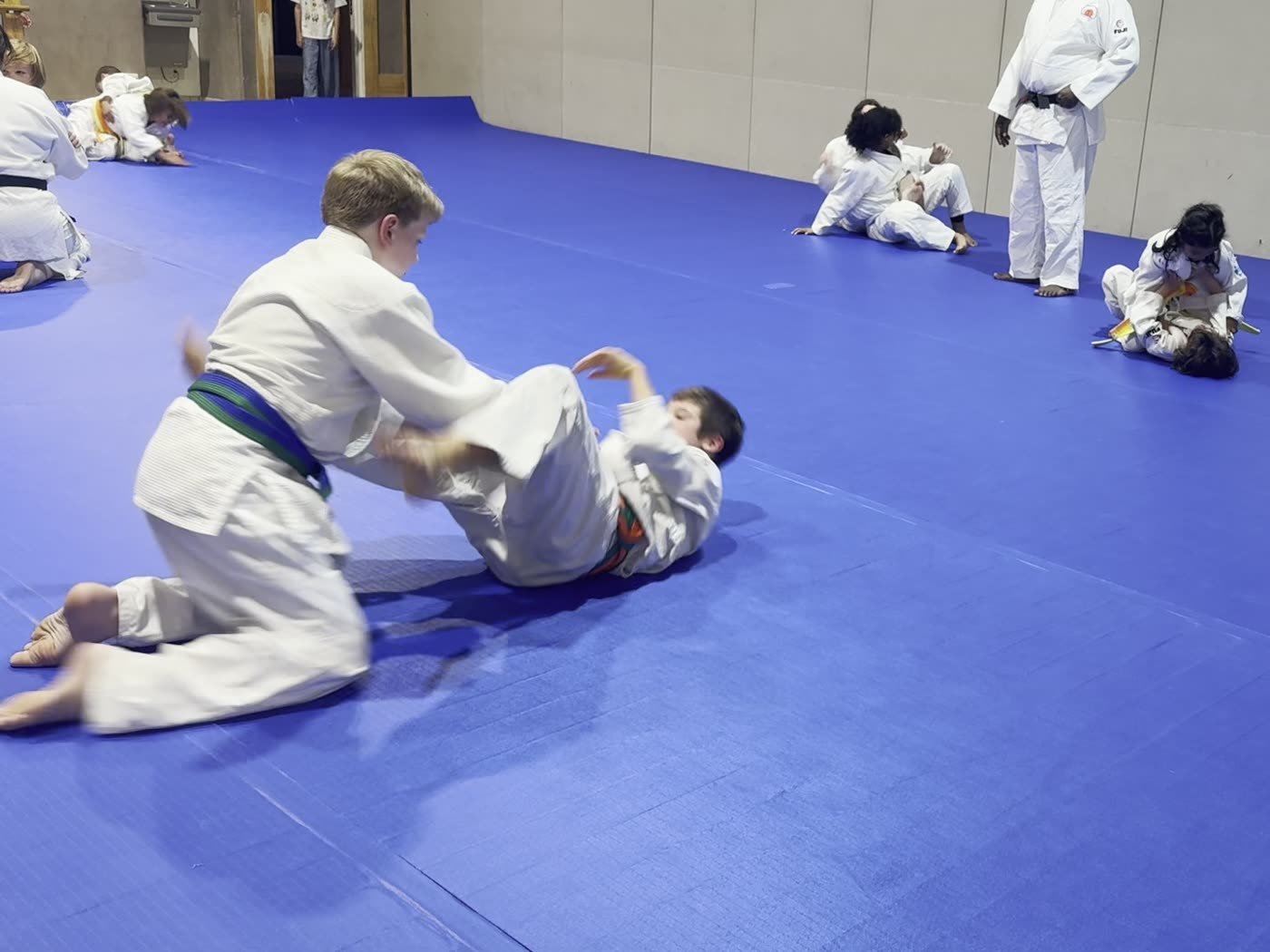 Two students grappling from their knees during groundwork practice
